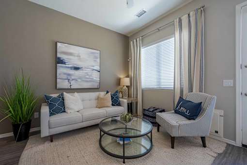 Modern living room with striped accent chair at Vistoria On Mountain View Apartments, Surprise, AZ 85374