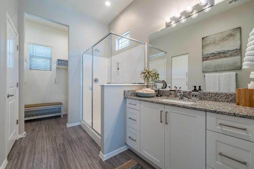 Master bathroom with glass shower enclosure at Vistoria On Mountain View Apartments, Surprise, Arizona
