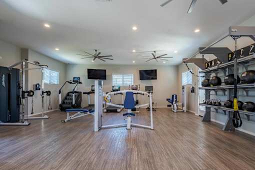 Fitness center with exercise equipment and weights at Vistoria On Mountain View Apartments, Arizona, 85374