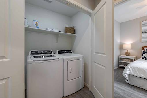 A small laundry room with a washer and dryer.