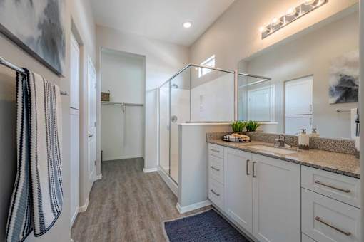 A bathroom with a striped towel hanging on the door.