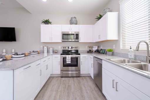 A modern kitchen with white cabinets and stainless steel appliances. at Vistoria At Country Place Apartments, Tolleson