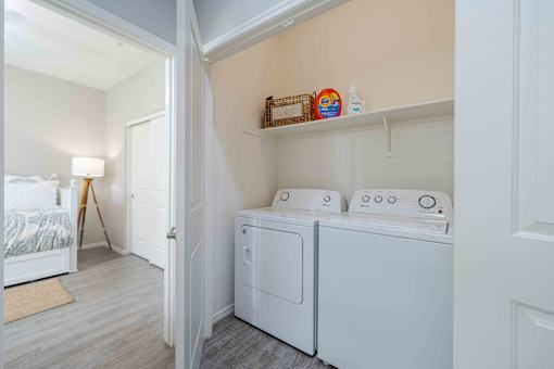 A small laundry room with a washer and dryer. at Vistoria At Country Place Apartments, Arizona