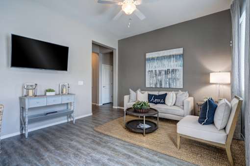 Modern living room with gray sofa at Vistoria On Camelback Apartments, Arizona