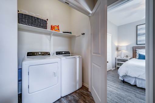 A small laundry room with a washer and dryer.