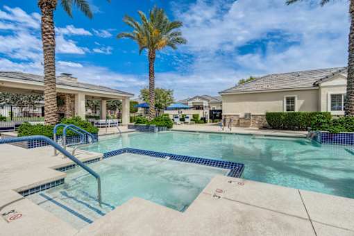 Resort style pool with spa and palm trees at Vistoria On Camelback Apartments, Litchfield Park, AZ 85340