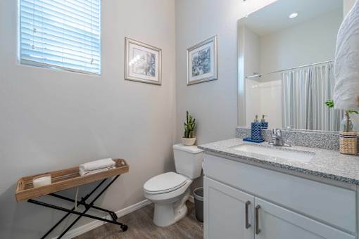 Modern bathroom with granite countertop vanity at Vistoria On Greenway Apartments, Arizona, 85379