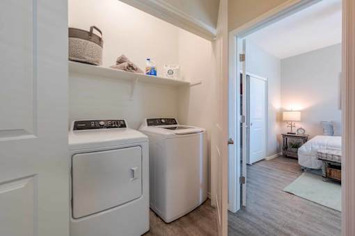 In unit washer and dryer with shelving at Vistoria On Greenway Apartments, Surprise, AZ 85379