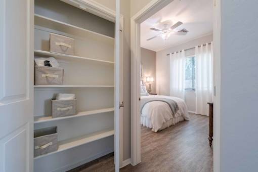 Bedroom with built in storage shelving at Vistoria On Greenway Apartments, Surprise, AZ