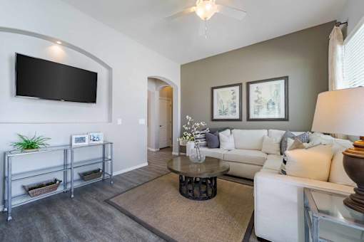 Contemporary living room with mounted television at Vistoria On Greenway Apartments, Surprise, AZ