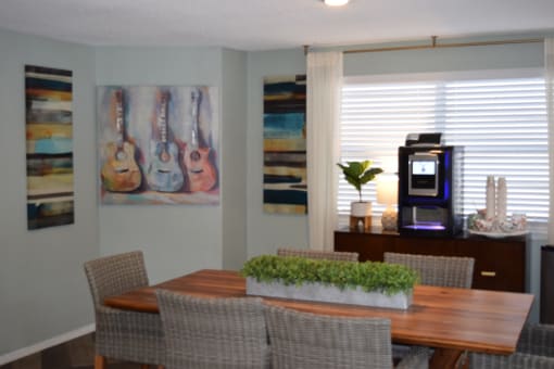 a dining room with a table and chairs and a coffeemaker  at Somerset Apartments, Largo