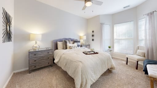 a bedroom with a bed and a ceiling fan