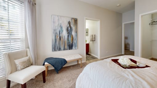 a bedroom with a bed and a painting on the wall