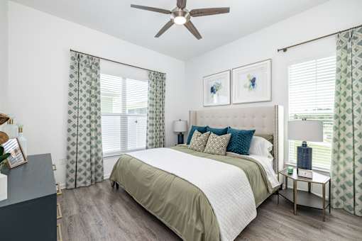 a bedroom with a large bed and a ceiling fan at Artesia at Lakewood Ranch Apartments, Bradenton, FL, 34211