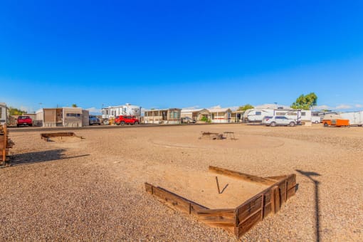 an rv park with a dirt field in front of it