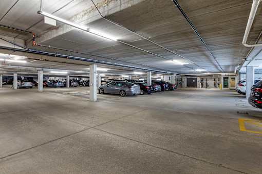 the parking garage is filled with parked cars