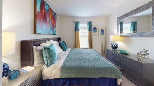 a bedroom with a large bed and a dresser with a mirror at Integra 360 Apartments, Winter Springs, FL