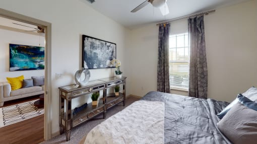 a bedroom with a large bed and a ceiling fan at Integra 360 Apartments, Winter Springs, FL, 32708