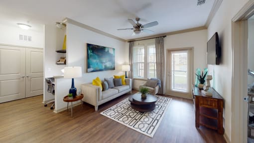 a living room with hardwood floors and a ceiling fan at Integra 360 Apartments, Winter Springs, FL, 32708