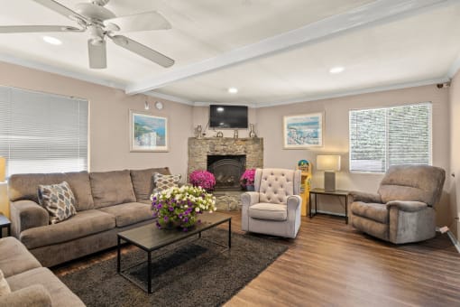 a living room with couches chairs and a fireplace