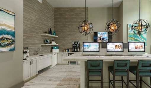 a room with a table with computers on it at The Addison on Long Bayou Apartments, Seminole, 33772