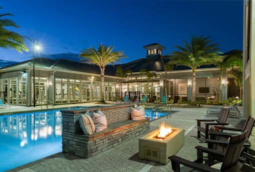 the swimming pool at night at the resort at The Addison on Long Bayou Apartments, Seminole