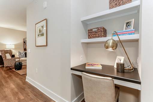 an office with a desk and a chair and a living room with a couch at Annandale Apartment Homes, Tennessee