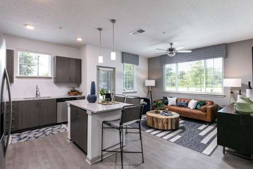 A modern kitchen with a dining area and a living room at Enclave at 3230 Apartments, South Daytona, 32119