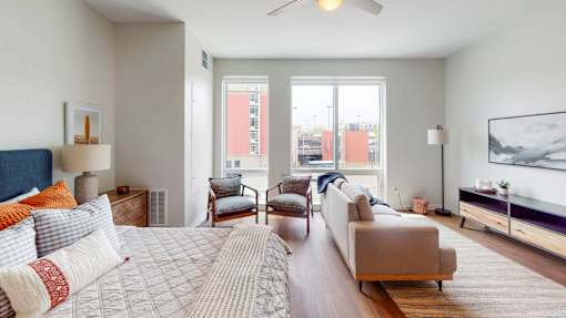 A bedroom with a large bed and a couch. at The Arlow on Kellog, St. Paul, MN, 55102