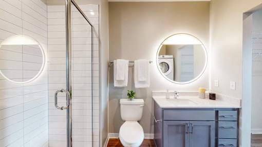 A white toilet sits in a bathroom next to a sink. at The Arlow on Kellog, Minnesota, 55102