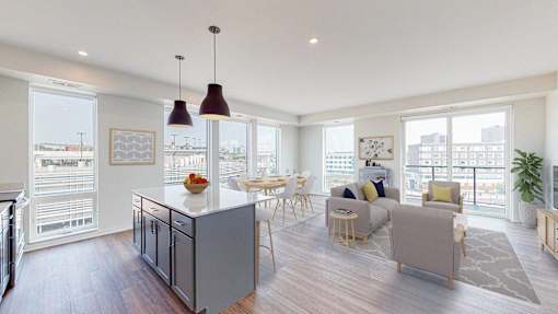 A modern kitchen with a dining table and chairs. at The Arlow on Kellog, St. Paul, MN