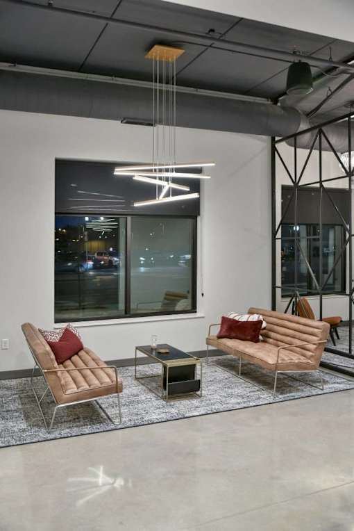 A modern living room with a large window and a view of the city at night. at The Arlow on Kellog, Minnesota