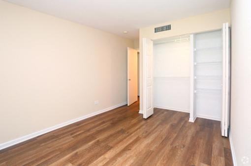 A room with wooden floors and a white door.
