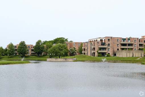 A lake in front of apartment buildings.