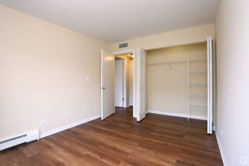 A room with a white door and a white closet.
