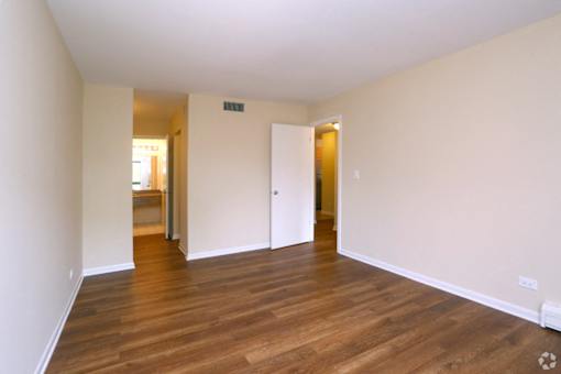 A room with wooden floors and white walls.