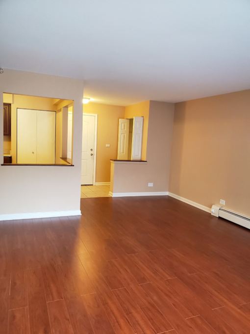 A room with wooden floors and a white door.