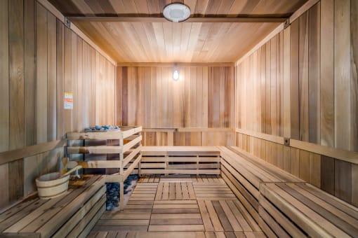 an empty finnish sauna with wooden walls and floors