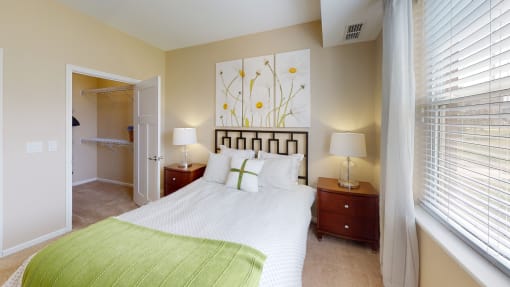 a bedroom with a bed and two night stands with lamps at Skye at Arbor Lakes, Maple Grove, MN