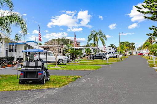 A golf cart is parked on the side of a street.