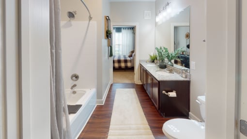 a bathroom with a tub and a sink at The Bend Arbordale, Virginia, 23188