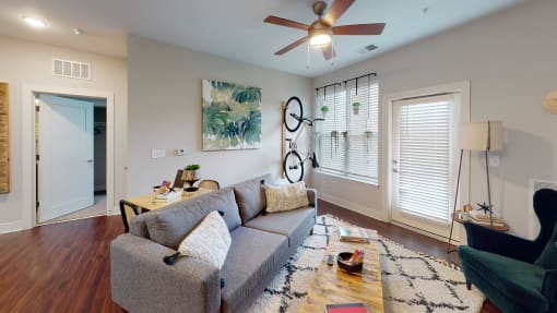 a living room with a couch and a coffee table at The Bend Arbordale, Williamsburg