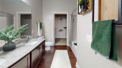 a bathroom with a toilet sink and bathtub at The Bend Arbordale, Virginia, 23188
