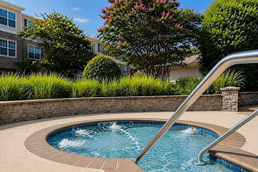 A small round pool with a metal railing.