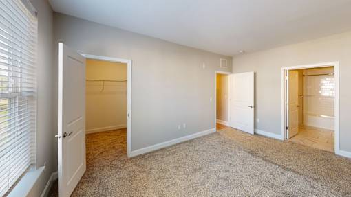 a bedroom with a closet and a door to a bathroom at The Landing Apartment , Hazlet, 07730