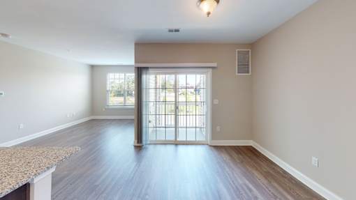 a bedroom with hardwood flooring and a door leading to a balcony at The Landing Apartment , Hazlet, New Jersey