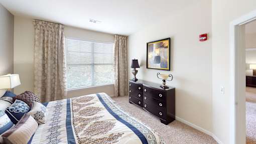 a bedroom with a large window at The Reserve at Riverdale, Riverdale, New Jersey