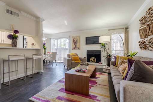 A living room with a fireplace and a couch.at 2400 Briarwest Apartments, Texas, 77077