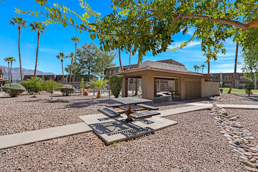a view of a courtyard with trees and a building at Verde Apartments