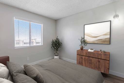 A bedroom with a bed, a dresser, and a painting on the wall.